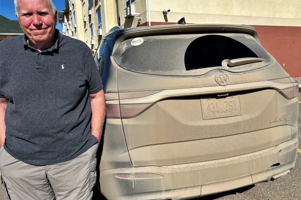 Me and our Buick at the end of our 1,300 mile trip down the full length of the Alcan Highway which runs from Delta Junction, Alaska to Dawson Springs, Canada. Photo by Melinda Craig.