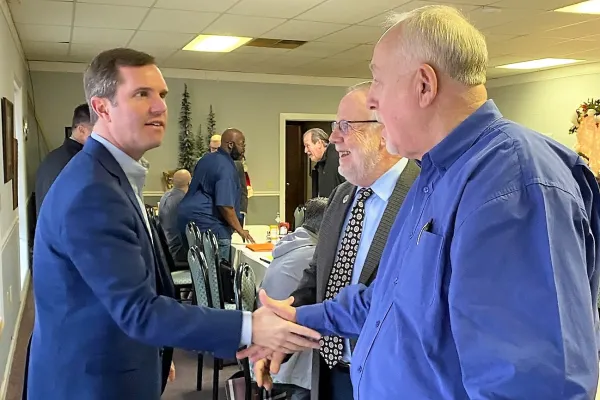 From left, Beshear, Londrigan and the UMWA's Steve Earle. Photo by LILES TAYLOR