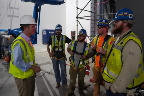 Beshear talking to workers. Governor's office photo