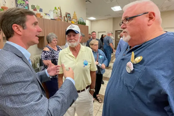 Gov. Beshear speaks with retired USW member Greg Weatherford at the Bardwell fundraiser. Looking on is retired Steelworker Kenny Tyler. Both are Carlisle countians. Photo by BERRY CRAIG 