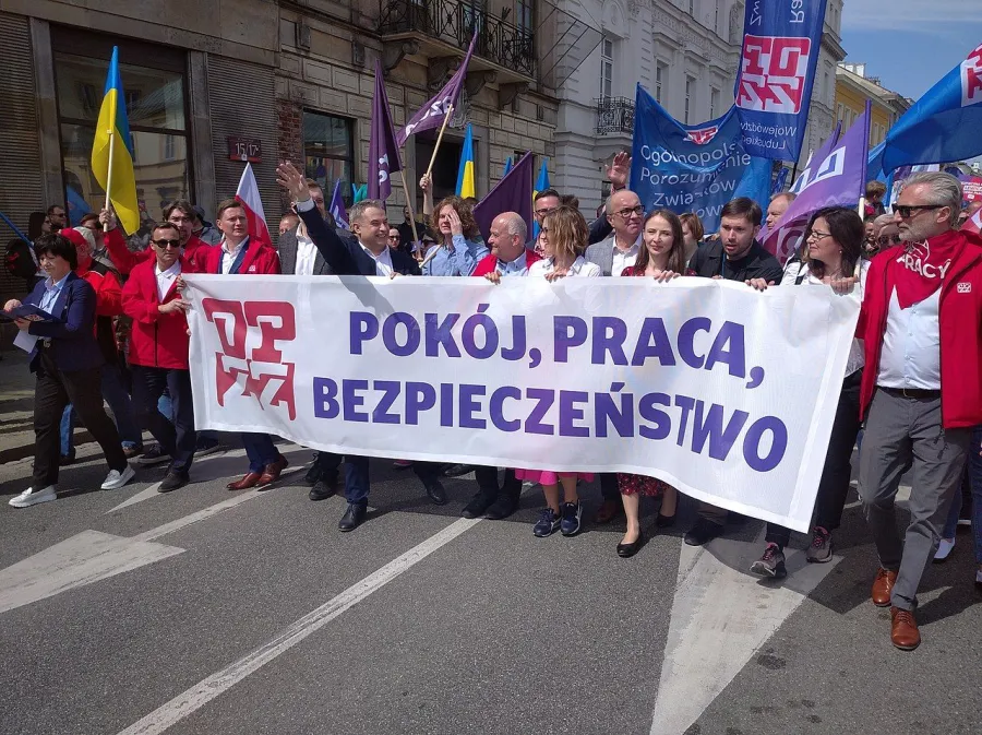 International Workers’ Day in Poland. The banner says “peace, work, security.” (Photo by Tomasz Molina [CC BY-SA 4.0] via Wikimedia Commons)
