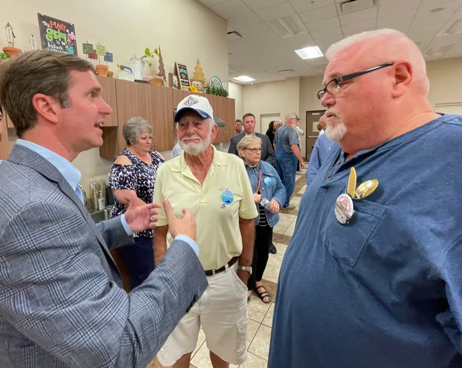 Gov. Beshear speaks with retired USW member Greg Weatherford at the Bardwell fundraiser. Looking on is retired Steelworker Kenny Tyler. Both are Carlisle countians. Photo by BERRY CRAIG 